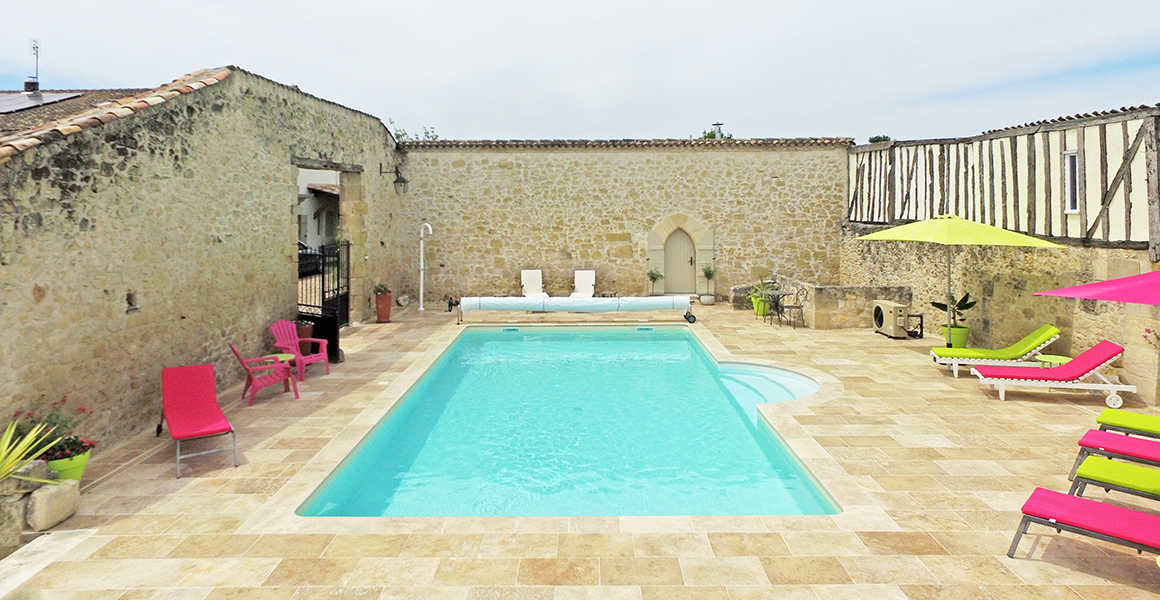 The pool is enclosed by three walls of the old barn