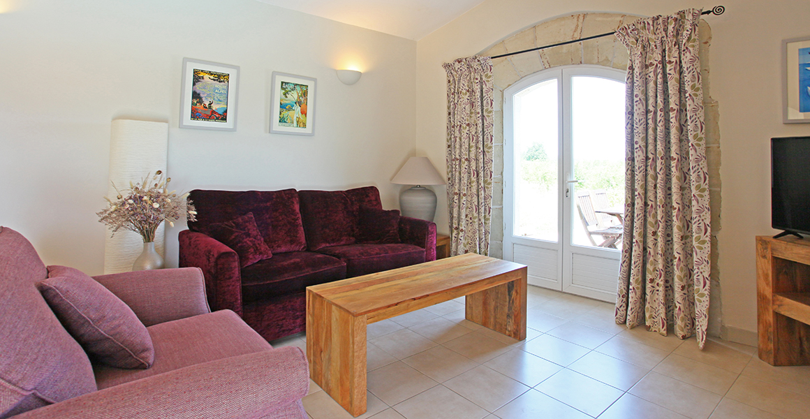 Gite lounge area with double doors out to the private terrace