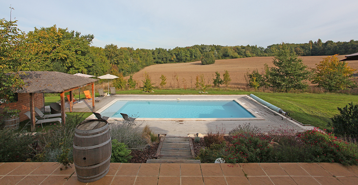 The pool overlooks fields and farmland