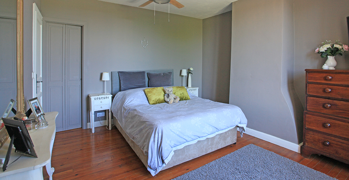 Farmhouse bedroom with connecting door to twin bunk room