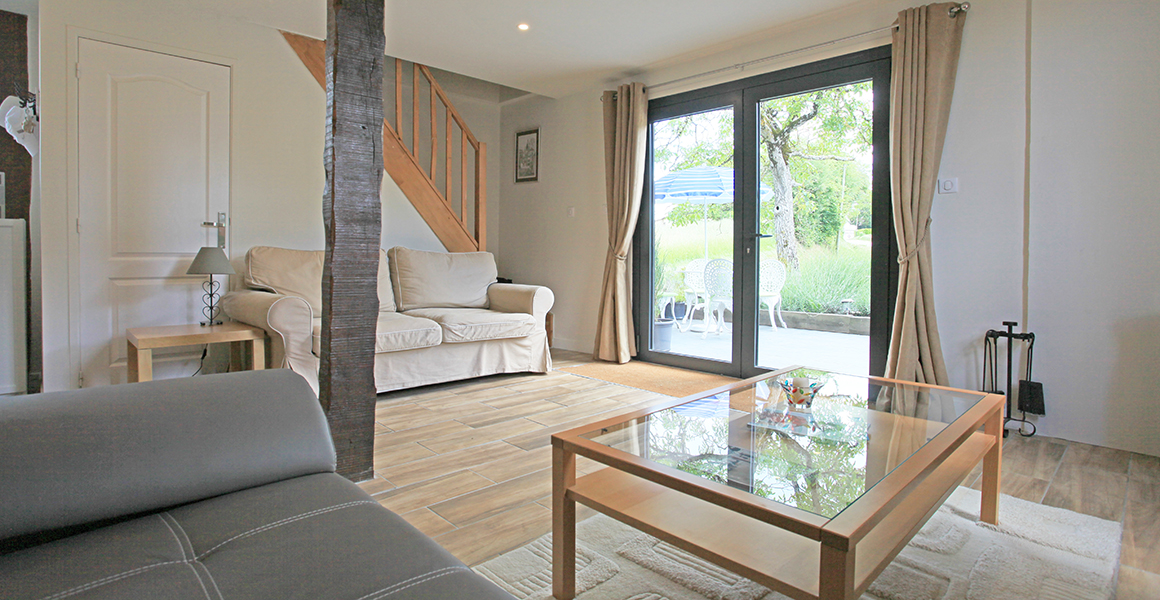 The front terrace leads into the sitting room, with stairs to the double and twin bedrooms