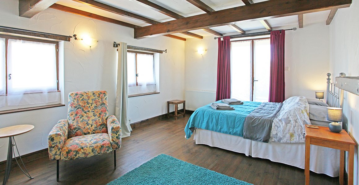 The ground floor double bedroom with doors out to a small terrace