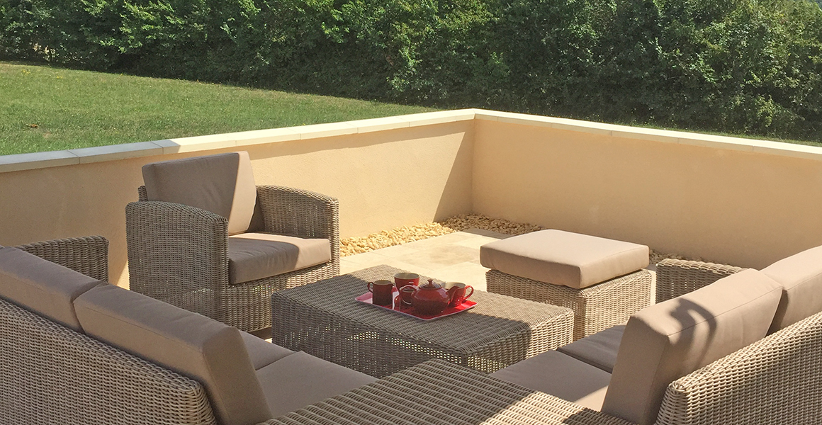 Comfortable outdoor furniture on the terrace to the side of the house