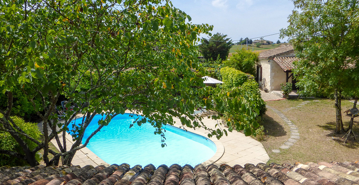 The view from the Farmhouse towards the pool and gite Pomegranate 